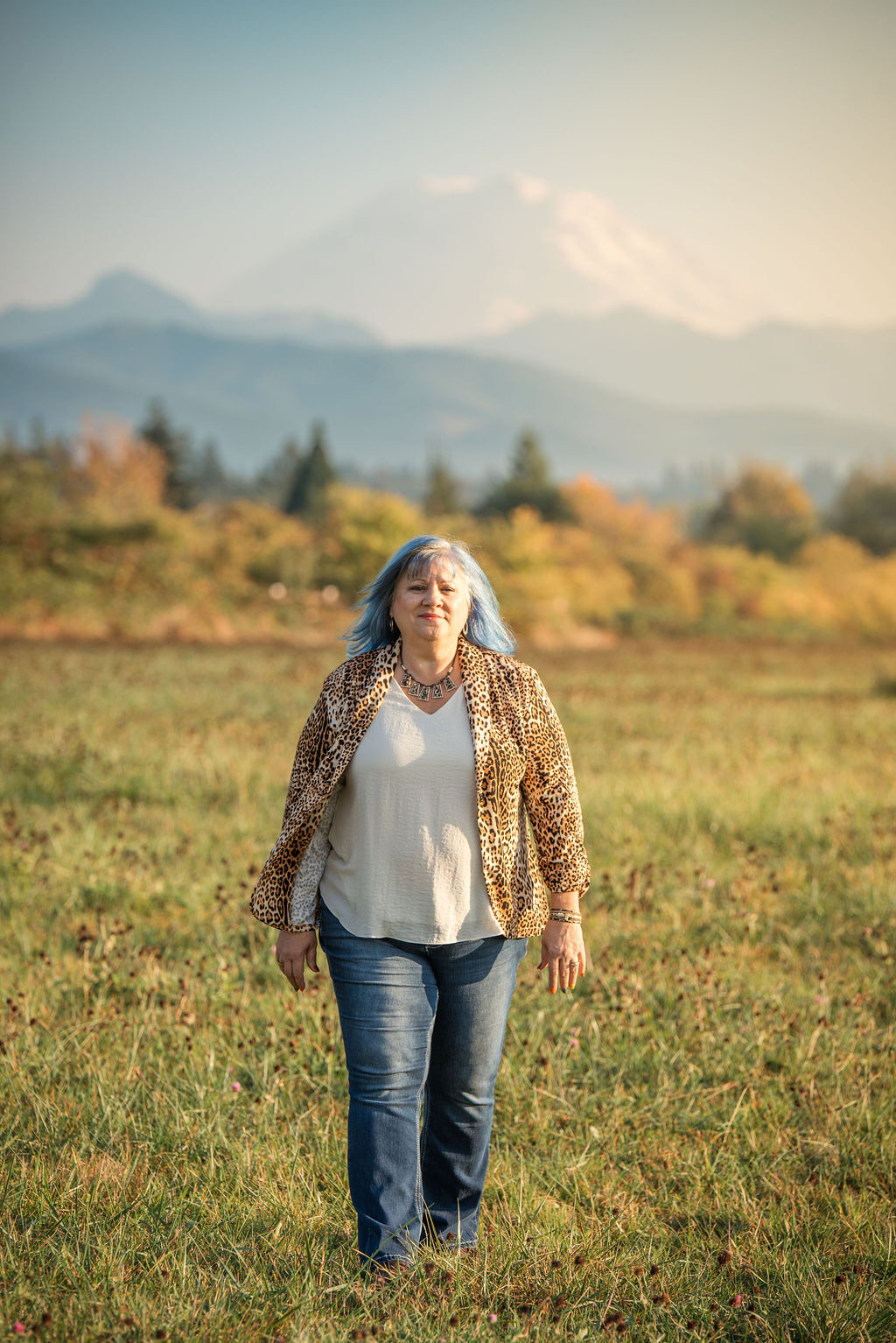 Eva Miller standing outdoors with a mountain in the distance